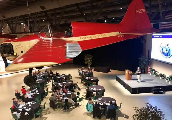 Plane hanging over attendees at a SOLIDWORKS roll out event at the EAA