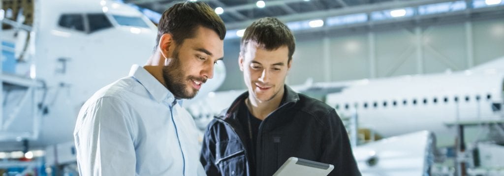 Two men staring over screen