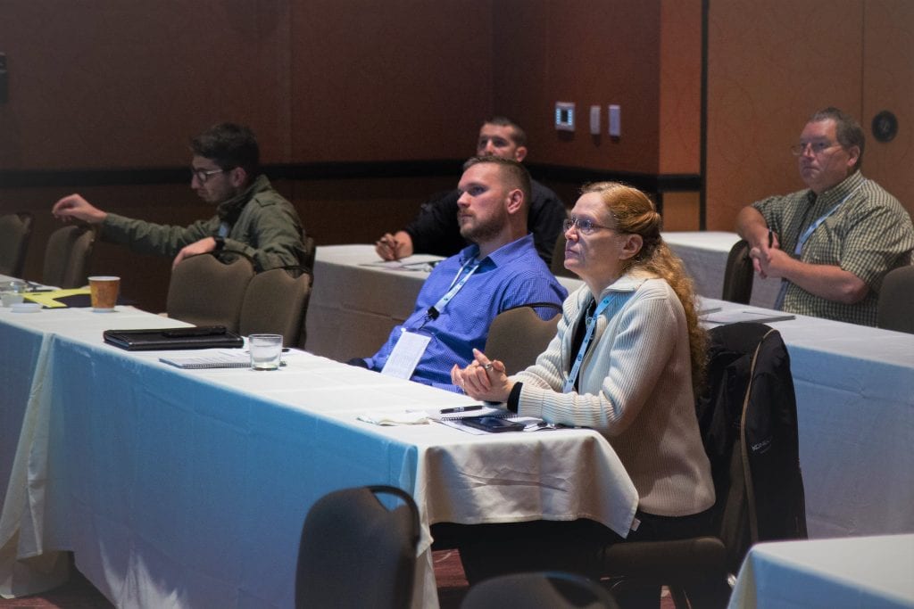 Attendees listening in intently on a session