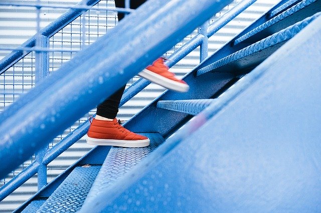 Close up of sneakers ascending outdoor stairs