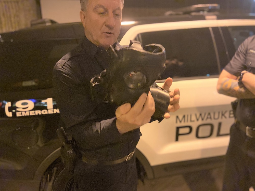 Individual police officer holding mask