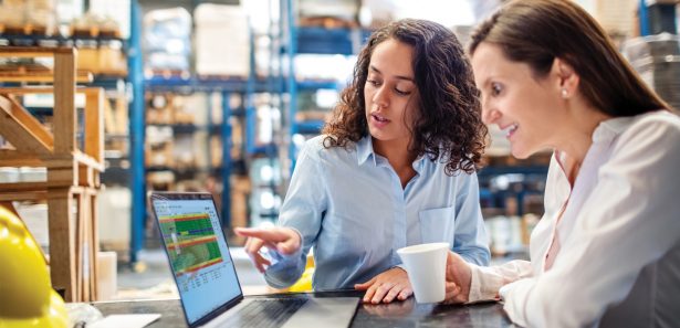 Two women collaborating and talking about scheduling capabilities