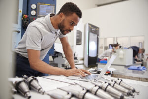 Male Engineer Using CAD Programming Software On Laptop Male Engineer Using CAD Programming Software On Laptop